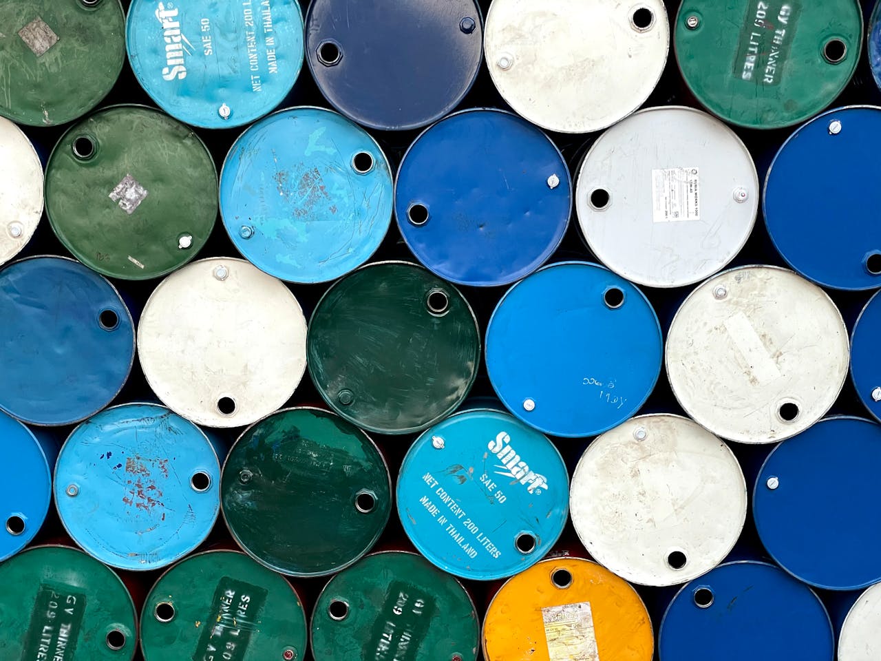 Vibrant stacked metal drums showcasing recycling in Mandalay, Myanmar.